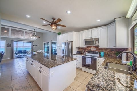 Kitchen is fully stocked with utensils, pots, pans, baking dishes, plates, bowls etc..