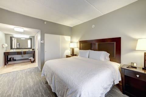 Premium bedding, desk, laptop workspace, blackout drapes