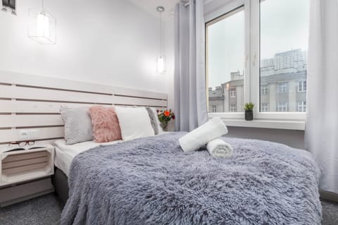 Comfortable bedroom with a double bed and wardrobe.