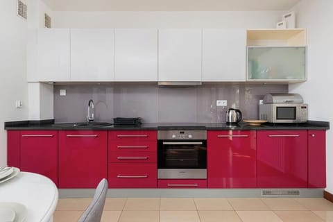 Kitchenette with oven and refrigerator.