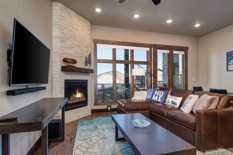 Living Room with 49” TCL Roku Smart TV, Gas Fireplace, Plush Leather Furnishings with built-in Storage, and Queen Sofa Sleeper