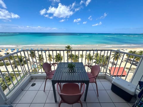 Peaceful balcony views of the beach, dotted with gentle rows of umbrellas
