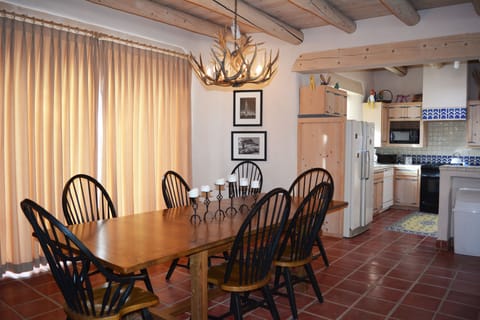 Tile floors, Jumbo sliding glass doors to patio hot tub and outdoor dining looking toward well equipped kitchen