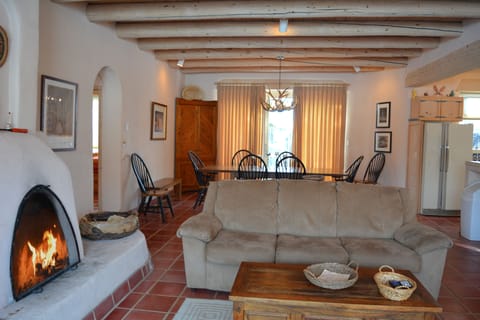 Fireplace views to dining table and entry hall on left to both guest bedrooms