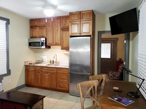 Kitchenette in den area with bedroom entrance to right.