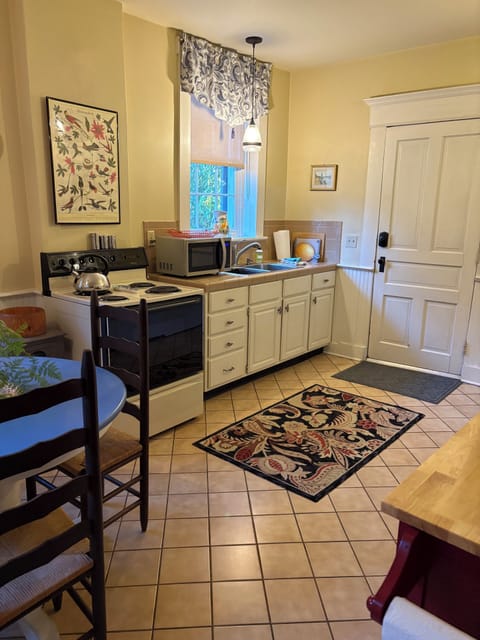 Full kitchen with stove, refrigerator, microwave
