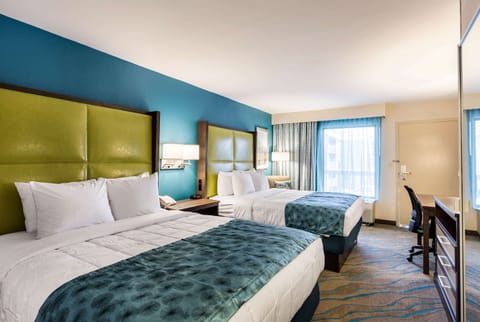 Premium bedding, desk, laptop workspace, blackout drapes