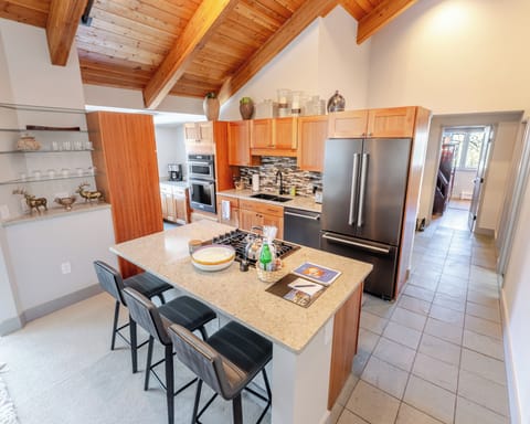 Your spacious gourmet kitchen invites you to create culinary masterpieces under stunning exposed beam ceilings, with modern appliances and a welcoming island.