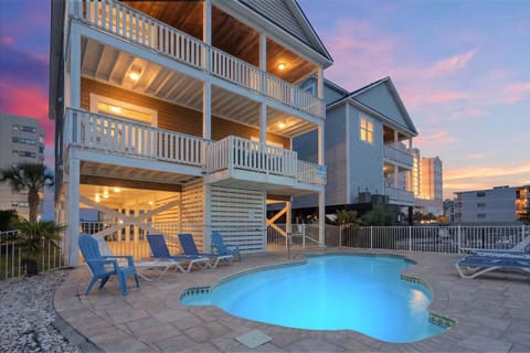 Pool deck and tiered balconies at Another Day in Paradise, a 6-bedroom Cherry Grove rental from Thomas Beach Vacations