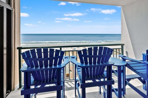 Balcony with blue chairs and ocean views at Beachwalk Villas 406, a 3-bedroom Cherry Grove condo from Thomas Beach Vacations