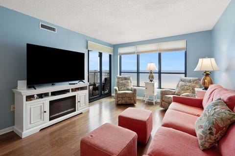 Living area with ocean views and balcony doors at Windemere 703, a 3-bedroom Ocean Drive condo from Thomas Beach Vacations