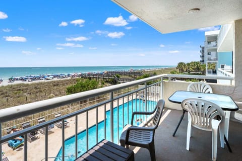 Balcony table overlooking the pool and beach at Shoreham Towers II 2D, a 3-bedroom condo from Thomas Beach Vacations