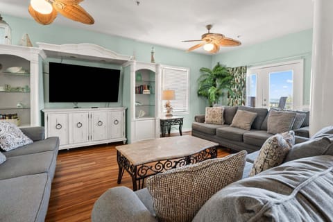 Sectional seating and a wide TV in the living area at Diamond Dunes A, an 8-bedroom Crescent Beach rental