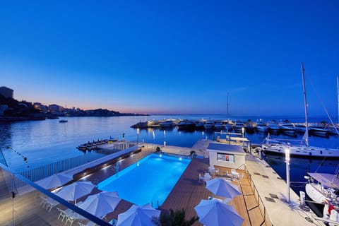 Seasonal outdoor pool, open 10:00 AM to 8:00 PM, pool umbrellas
