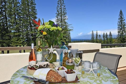 Furnished lanai with dining set overlooking lush golf course and blue skies.