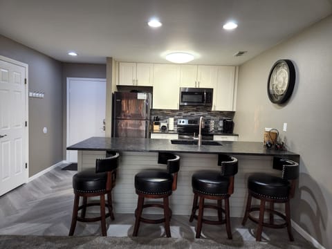 Slate stainless steel appliances with a glass back splash.