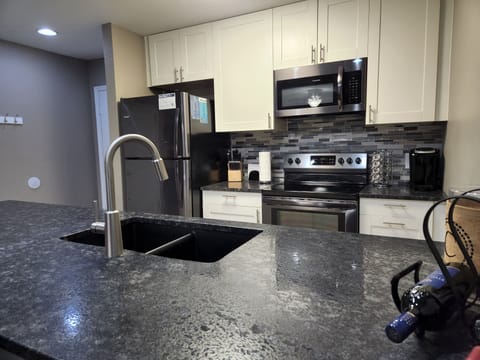 Caressed granite counters with a well stocked kitchen.