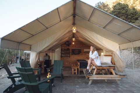 Spacious glamping tent with covered outdoor living space, cozy beds, dining area, and everything you need for a comfortable Southern Utah stay.