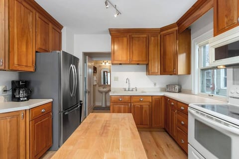 The half bathroom is located off the kitchen. There is ample counterspace and a small island in the kitchen.