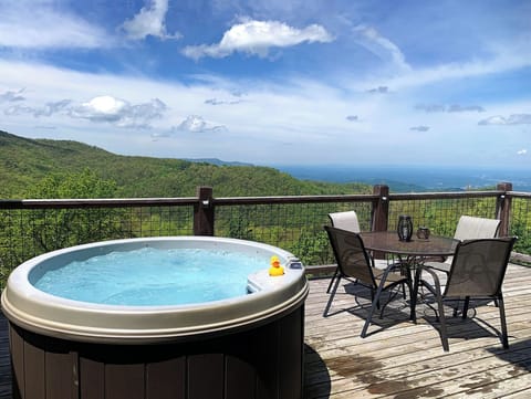 Private hot tub, peaceful deck, and long-range mountain scenery.