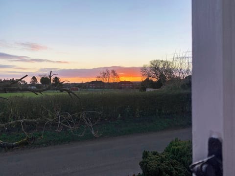 Wonderful sunrise view from bedroom | Vine Cottage - Clevency Cottages, Great Snoring, near Fakenham