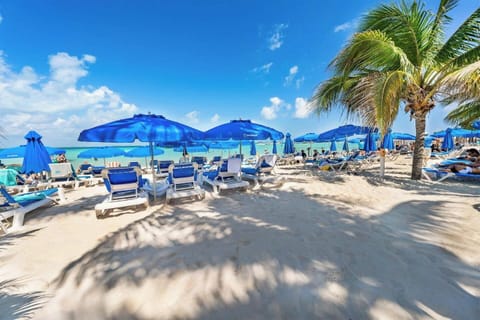 Beach front Nautibeach condo with direct beach access and pool, perfect for family friendly vacations.