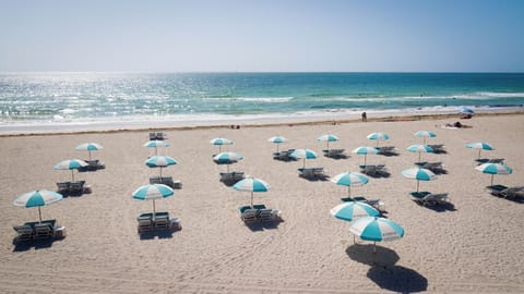 Beach nearby, white sand, sun loungers, beach towels