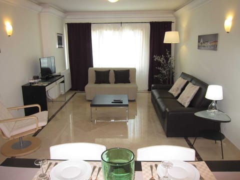 Livingroom with tv, heater, a/c, windows with electric blinds