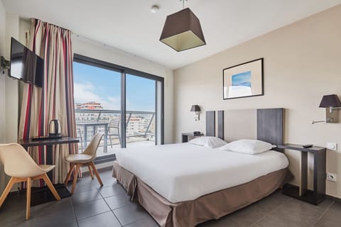 Modern and cozy Superior Studio with sleek furnishings and large windows opening to the outdoors. Some units include a balcony—please request when booking and we’ll do our best to accommodate.