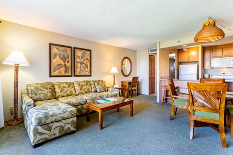 Unwind in your spacious living area with tropical-inspired decor and warm island charm. Open-concept layout flows seamlessly to your fully equipped kitchen—perfect for family meals or evening relaxation after exploring nearby beaches.