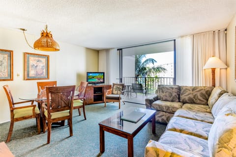 Relax in this airy living space with tropical decor, a comfy sectional sofa, and dining for four. Your private balcony beckons with island breezes and palm-framed views.