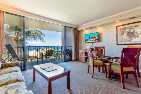 Picture yourself relaxing in this breezy living space where tropical breezes meet ocean views. Your private balcony overlooks swaying palms and sparkling blue waters, creating a serene retreat. Unwind with island-inspired décor, comfortable seating, and a 