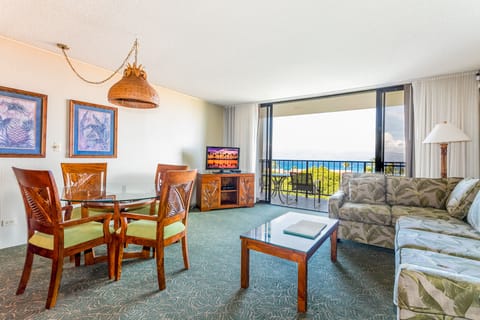 Relax in your bright, island-inspired living space where tropical breezes and stunning ocean views become part of your everyday retreat through the open balcony doors.