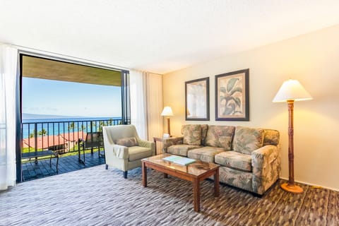 Relax in your private living room where gentle ocean breezes and stunning sea views pour through the balcony doors, creating the perfect retreat after sunny beach days.