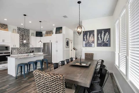 Another angle of the dining space, showing bright windows & relaxed seating