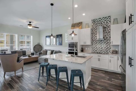 Open kitchen w/ island seating, modern finishes & room to gather