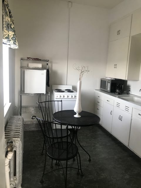 Full kitchen, stocked with pots and pans, dinner ware and utensils.