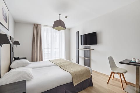 Bright, spacious room with a comfortable bed, work desk, and natural light from the large window.