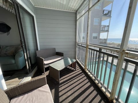 Screen porch with ocean and pool views