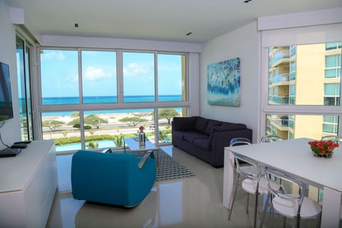 Soak in stunning ocean views from your bright, modern living space where coastal blues meet contemporary comfort, inviting you to unwind and savor every moment of your beachfront escape.
