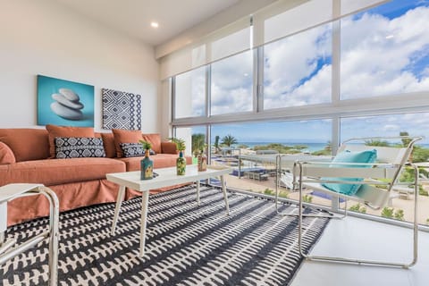 Sink into plush seating with your favorite book as ocean breezes drift through floor-to-ceiling windows, framing endless sea and sky views that make every moment feel like a private escape.
