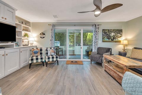 Ocean Walk M2 - Living room with ceiling fan, plaid chairs, and sliding glass doors