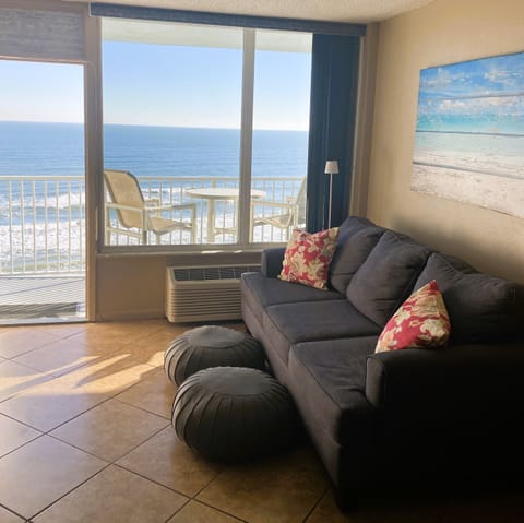 Couch/hide a bed across from flat screen TV. Open door to Ocean view.