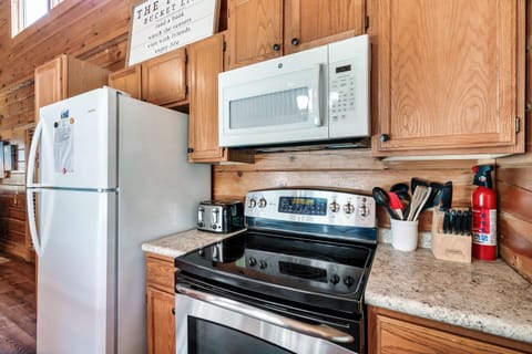 Fully stocked kitchen with outdoor propane grill.