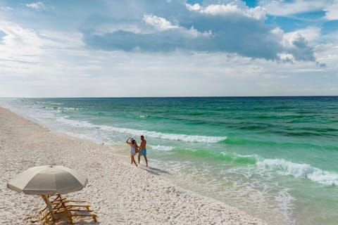 Indulge in the calm and solitude under a beach umbrella, with the soothing sounds of the sea.