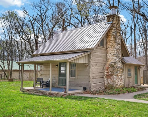 Cozy cabin retreat with rustic stone fireplace and porch