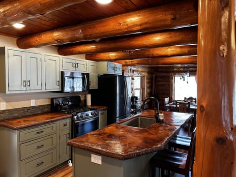 open kitchen with black stainless steel appliances
