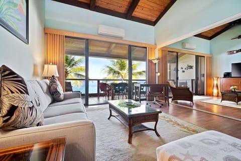Oceanfront living room off of the dining room. Step into a light-filled living room with floor-to-ceiling ocean views — hear the surf, feel the breeze, and enjoy total oceanfront comfort with full A/C.