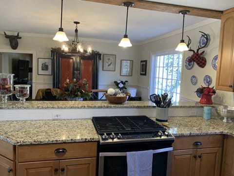 Kitchen - gas stove, dining room view and bar