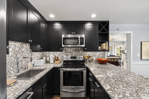 The modern kitchen is updated with beautiful stone and appliances